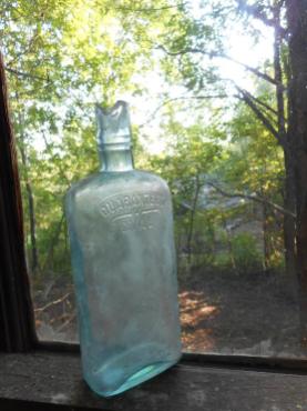 bottle In the garage on the window sill watching the days come and go ...